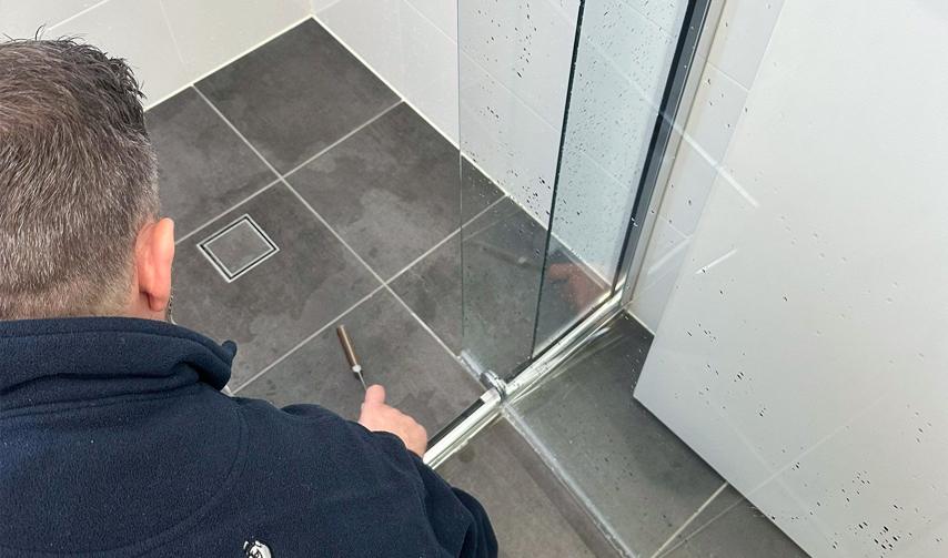 Bathroom shower leak repair and resealing service by technician